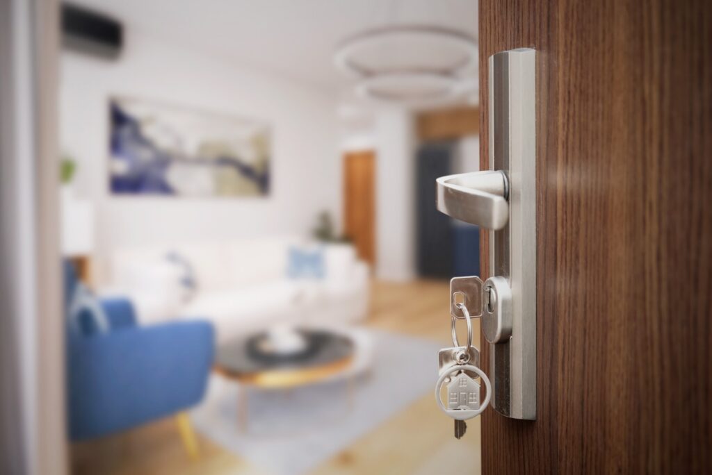 Door knob with key in a living room, with a lock and key nearby
